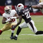 San Francisco 49ers running back Carlos Hyde (28) tries to avoid Arizona Cardinals free safety Tony Jefferson (22) during the first half of an NFL football game Sunday, Sept. 21, 2014, in Glendale, Ariz. (AP Photo/Ross D. Franklin)
