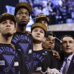 Duke head coach Mike Krzyzewski watches the One Shining Moment tribute with his team after their 68-63 victory over Wisconsin in the NCAA Final Four college basketball tournament championship game Monday, April 6, 2015, in Indianapolis. (AP Photo/David J. Phillip)