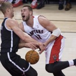Toronto Raptors forward Jonas Valanciunas, right, drives into Brooklyn Nets forward Mason Plumlee during the first half of Game 2 in an NBA basketball first-round playoff series, Tuesday, April 22, 2014, in Toronto. (AP Photo/The Canadian Press, Nathan Denette)