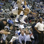 Dallas Mavericks center Tyson Chandler (6) leaps while warming up before the tip off an NBA basketball game against the Phoenix Suns Friday, Dec. 5, 2014, in Dallas. (AP Photo/LM Otero)
