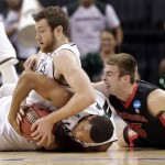 Michigan State's Marvin Clark Jr, center, and Matt Costello, left, battle with Georgia's Kenny Paul Geno, right, for a loose ball during the first half of an NCAA tournament college basketball game in the Round of 64 in Charlotte, N.C., Friday, March 20, 2015. (AP Photo/Nell Redmond)
