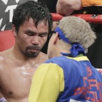 Manny Pacquiao, left, stands with trainer Freddie Roach at the finish of his welterweight title fight against Floyd Mayweather Jr. on Saturday, May 2, 2015 in Las Vegas. (AP Photo/Isaac Brekken)
