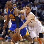 Golden State Warriors guard Leandro Barbosa (19) tries to keep the ball from Phoenix Suns guard Goran Dragic (1) during the first quarter during an NBA basketball game, Sunday, Nov. 9, 2014, in Phoenix. The Suns won 107-95. (AP Photo/Rick Scuteri)