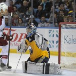 Arizona Coyotes right win David Moss (18) watches a shot by Oliver Ekman-Larsson get past Buffalo Sabres goaltender Matt Hackett (31) for a goal during the second period of an NHL hockey game Thursday, March 26, 2015, in Buffalo, N.Y. The Coyotes won in overtime 4-3. (AP Photo/Gary Wiepert)