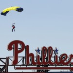 A member of the U.S. Navy parachute demonstration team, the Leap Frogs, jumps into the stadium before an opening day baseball game between the Philadelphia Phillies and the Boston Red Sox Monday, April 6, 2015, in Philadelphia. (AP Photo/Matt Rourke)