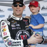 Kevin Harvick poses with his son Keelan after winning the pole for Sunday's NASCAR Sprint Cup Series auto race, Friday, March 13, 2015, in Avondale, Ariz. (AP Photo/Rick Scuteri)