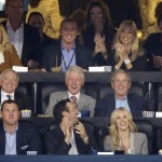 From center left, Dallas Cowboys owner Jerry Jones, former presidents Bill Clinton and George W. Bush and former first lady Laura Bush as well as Cowboys head coach Jason Garrett, second from top left, watch action between Connecticut and Kentucky during the first half of the NCAA Final Four tournament college basketball championship game Monday, April 7, 2014, in Arlington, Texas. (AP Photo/Tony Gutierrez)