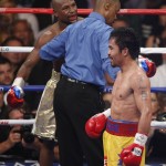Referee Kenny Bayless, center, separates Floyd Mayweather Jr., left, and Manny Pacquiao, from the Philippines, during their welterweight title fight on Saturday, May 2, 2015 in Las Vegas. (AP Photo/Eric Jamison)