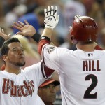 Arizona Diamondbacks' Aaron Hill (2) gets high-fives from teammate David Peralta after Hill hit a home run against the Detroit Tigers during the first inning of a baseball game on Tuesday, July 22, 2014, in Phoenix. (AP Photo)