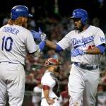 Los Angeles Dodgers' Howie Kendrick greets teammate Justin Turner (10) after hitting a solo home run against the Arizona Diamondbacks in the 10th inning of a baseball game, Tuesday, June 30, 2015, in Phoenix. (AP Photo/Matt York)