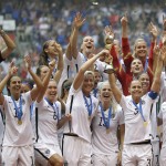 The United States Women's National Team celebrates with the trophy after they beat Japan 5-2 in the FIFA Women's World Cup soccer championship in Vancouver, British Columbia, Canada, Sunday, July 5, 2015. (AP Photo/Elaine Thompson)

