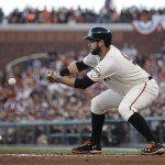 San Francisco Giants Brandon Belt bunts for a single during the second inning of Game 5 of baseball's World Series against the Kansas City Royals Sunday, Oct. 26, 2014, in San Francisco. (AP Photo/Matt Slocum)