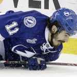 Tampa Bay Lightning center Brian Boyle (11) hits the ice after colliding with Chicago Blackhawks right wing Kris Versteeg (23) during the first period of Game 5 of the NHL hockey Stanley Cup Final, Saturday, June 13, 2015, in Tampa, Fla. (AP Photo/Chris O'Meara)