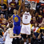 Cleveland Cavaliers center Tristan Thompson (13) dunks against Golden State Warriors guard Shaun Livingston (34) during the first half of Game 6 of basketball's NBA Finals in Cleveland, Tuesday, June 16, 2015. (AP Photo/Paul Sancya)
