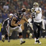 New Orleans Saints quarterback Drew Brees (9) throws a pass against Chicago Bears defensive tackle Stephen Paea (92) during the second half of an NFL football game Monday, Dec. 15, 2014, in Chicago. (AP Photo/Nam Y. Huh)