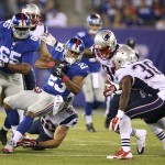 New York Giants running back Rashad Jennings (23) is brought down by New England Patriots' James Morris (52) during the first half of an NFL preseason football game, Thursday, Aug. 28, 2014, in East Rutherford, N.J. (AP Photo/John Minchillo)	