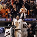 San Francisco Giants Gregor Blanco cheers after teammate Joe Panik (12) scored the go ahead run on a wild pitch in the seventh inning against the Washington Nationals during Game 4 of baseball's NL Division Series in San Francisco, Tuesday, Oct. 7, 2014. (AP Photo/Marcio Jose Sanchez)