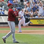 Arizona Diamondbacks relief pitcher Randall Delgado, left, reacts after allowing a fifth-inning solo home run to New York Mets' Kirk Nieuwenhuis, back right, who runs the bases during a baseball game in New York, Sunday, July 12, 2015. (AP Photo/Kathy Willens)
