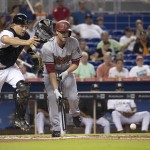 Miami Marlins catcher J.T. Realmuto (20) chases a foul ball after Arizona Diamondbacks' Archie Bradley (25) bunted during the second inning of a baseball game in Miami, Thursday, May 21, 2015. He bunted out with two on base. (AP Photo/J Pat Carter)