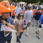 Jesus Gonzalez and Liz Gomez walk through the Opening Day Festival before a baseball game between the Houston Astros and Cleveland Indians, Monday, April 6, 2015, in Houston. (AP Photo/Patric Schneider)