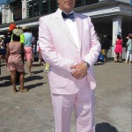 Alan Laughton of Louisville wears a pink seersucker suit at Churchill Downs before the 141st running of the Kentucky Oaks horse race at Churchill Downs Friday, May 1, 2015, in Louisville, Ky. (AP Photo/Gary Graves)