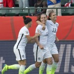 United States' Ali Krieger (11), Lauren Holiday (12) and Alex Morgan (13) celebrate a goal against Colombia during second half FIFA Women's World Cup round of 16 soccer action in Edmonton, Alberta, Canada, Monday, June 22, 2015. (Jason Franson/The Canadian Press via AP)
