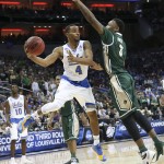 UCLA guard Norman Powell passes around UAB forward Chris Cokley during the second half of an NCAA tournament third round college basketball game in Louisville, Ky., Saturday, March 21, 2015. UCLA won the game 92-75. (AP Photo/David Stephenson)