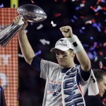 New England Patriots quarterback Tom Brady holds up Vince Lombardi Trophy after the Patriots defeated the Seattle Seahawks 28-24 in NFL Super Bowl XLIX football game Sunday, Feb. 1, 2015, in Glendale, Ariz. (AP Photo/Mark Humphrey)
