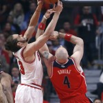 Chicago Bulls center Joakim Noah (13) battles Washington Wizards center Marcin Gortat for a rebound during the first half of Game 2 in an opening-round NBA basketball playoff series game Tuesday, April 22, 2014, in Chicago. (AP Photo/Charles Rex Arbogast)
