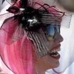 A woman wears a hat before the 141st running of the Kentucky Oaks horse race at Churchill Downs Friday, May 1, 2015, in Louisville, Ky. (AP Photo/Darron Cummings)