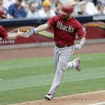 Arizona Diamondbacks' David Peralta, right, is greeted by third base coach Andy Green (14) after hitting a home run against the San Diego Padres during the third inning of a baseball game Sunday, June 28, 2015, in San Diego. (AP Photo/Gregory Bull)
