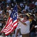 Pittsburgh Pirates fan Ed Sweeney waves a flag in the stands at PNC Park before a baseball game between the Pirates and the Philadelphia Phillies in Pittsburgh, Friday, July 4, 2014. (AP Photo/Gene J. Puskar)