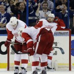 Detroit Red Wings defenseman Brendan Smith (2), defenseman Danny DeKeyser (65) and left wing Tomas Tatar (21), of Slovakia, react after Tampa Bay Lightning defenseman Anton Stralman, of Sweden, scored a goal during the third period of Game 7 of a first-round NHL Stanley Cup hockey playoff series Wednesday, April 29, 2015, in Tampa, Fla. The Lightning won the game 2-0. (AP Photo/Chris O'Meara)