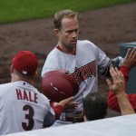 Arizona Diamondbacks manager Chip Hale, left, congratulates Arizona Diamondbacks third baseman Aaron Hill as he returns to the dugout after hitting a three-run home run against the Colorado Rockies in the fourth inning of the first game of a baseball doubleheader Wednesday, May 6, 2015, in Denver. (AP Photo/David Zalubowski)