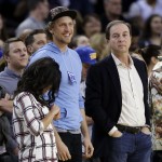 San Francisco Giants' Hunter Pence, left, stands next to Golden State Warriors owner Joe Lacob during the first half of an NBA basketball game against the Phoenix Suns Saturday, Jan. 31, 2015, in Oakland, Calif. (AP Photo/Marcio Jose Sanchez)