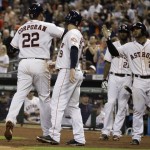 Houston Astros's Carlos Corporan is congratulated by teammates as he hits a home run to left field during the fourth inning of a baseball game against the Arizona Diamondbacks, Thursday, June 12, 2014, in Houston. Robbie Grossman also scored. (AP Photo/Patric Schneider)