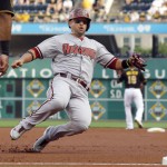  Arizona Diamondbacks' Martin Prado, left, takes third from first on a hit by Paul Goldschmidt as Pittsburgh Pirates second baseman Neil Walker (18) waits for the relay throw at second in the first inning of the baseball game on Tuesday, July 1, 2014, in Pittsburgh. (AP Photo/Keith Srakocic)