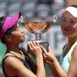 Su-Wei Hsieh, of Taipei, left, and China's Peng Shuai hold their cup after winning the women's doubles final match of the French Open tennis tournament against Italy's Sara Errani and Roberta Vinci at the Roland Garros stadium, in Paris, France, Sunday, June 8, 2014. (AP Photo/Thibault Camus)
