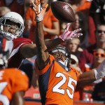 Denver Broncos cornerback Chris Harris (25) breaks up a pass intended for Arizona Cardinals wide receiver Michael Floyd during the first half of an NFL football game, Sunday, Oct. 5, 2014, in Denver. (AP Photo/Jack Dempsey)
