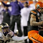Oklahoma State wide receiver Brandon Sheperd, right, scores a touchdown as Washington defensive back Sidney Jones defends during the first half of the Cactus Bowl NCAA college football game, Friday, Jan. 2, 2015, in Tempe, Ariz. (AP Photo/Rick Scuteri)