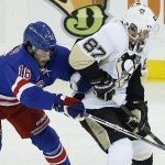 New York Rangers center Derick Brassard (16) battles Pittsburgh Penguins center Sidney Crosby (87) for the puck during the second period of Game 5 in the first round of the NHL hockey Stanley Cup playoffs, Friday, April 24, 2015, in New York. (AP Photo/Julie Jacobson)