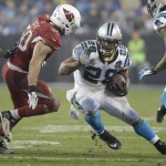 Carolina Panthers' Jonathan Stewart (28) runs as Arizona Cardinals' Larry Foote (50) defends in the second half of an NFL wild card playoff football game in Charlotte, N.C., Saturday, Jan. 3, 2015. (AP Photo/Bob Leverone)