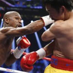 Floyd Mayweather Jr., left, punches Manny Pacquiao, from the Philippines, during their welterweight title fight on Saturday, May 2, 2015 in Las Vegas. (AP Photo/John Locher)