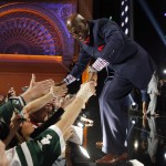 Former Green Bay Packers wide receiver Donald Driver greets fans after announcing that the Packers select Miami of Ohio defensive back Quinten Rollins as the 62nd pick in the second round of the 2015 NFL Football Draft, Friday, May 1, 2015, in Chicago. (AP Photo/Charles Rex Arbogast)