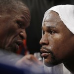 Floyd Mayweather Jr., right, listens to his father, head trainer Floyd Mayweather Sr., between rounds during his welterweight title fight against Manny Pacquiao, from the Philippines, on Saturday, May 2, 2015 in Las Vegas. (AP Photo/Isaac Brekken)