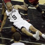San Antonio Spurs guard Tony Parker (9) lands on the ball against the Miami Heat during the first half in Game 1 of the NBA basketball finals on Thursday, June 5, 2014, in San Antonio. (AP Photo/Tony Gutierrez)