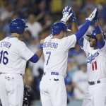 Los Angeles Dodgers shortstop Jimmy Rollins, right, celebrates his three-run home run after driving in Alex Guerrero, center, and Andre Ethier, left, during the fourth inning of a baseball game against the Arizona Diamondbacks, Monday, June 8, 2015, in Los Angeles. (AP Photo/Danny Moloshok)