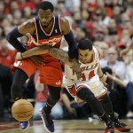 Washington Wizards guard John Wall, left, steals the ball from Chicago Bulls guard D.J. Augustin during the first half in Game 1 of an opening-round NBA basketball playoff series in Chicago, Sunday, April 20, 2014. (AP Photo/Nam Y. Huh)