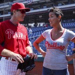 Philadelphia Phillies' Chase Utley, left, reacts to getting a pair of underwear from cancer survivor Julie Kramer, right, during warm-ups prior to the first inning of an opening day baseball game against the Boston Red Sox, Monday, April 6, 2015, in Philadelphia. (AP Photo/Chris Szagola)