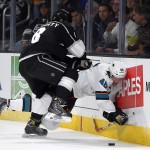 San Jose Sharks center Tomas Hertl, right, of the Czech Republic, is pushed into the boards by Los Angeles Kings defenseman Drew Doughty during the first period of an NHL hockey game, Wednesday, Oct. 8, 2014, in Los Angeles. Doughty received a penalty for boarding on the play. (AP Photo/Mark J. Terrill)